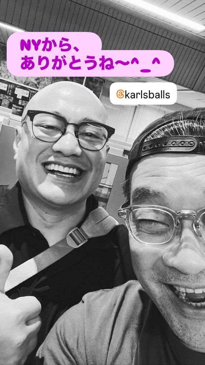 Black-and-white selfie of Karl and Sakuramoto Masahide (Saku-chan) laughing together at Tenpu, October 21, 2026; his sticker reads: Thanks for coming from NY